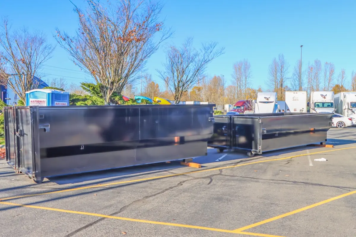 Professional dumpster rental service with roll-off container on residential driveway in Sun City